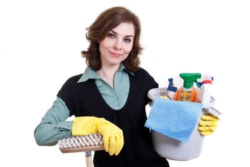 Deep cleaning a bathroom with scrub brush and cloth